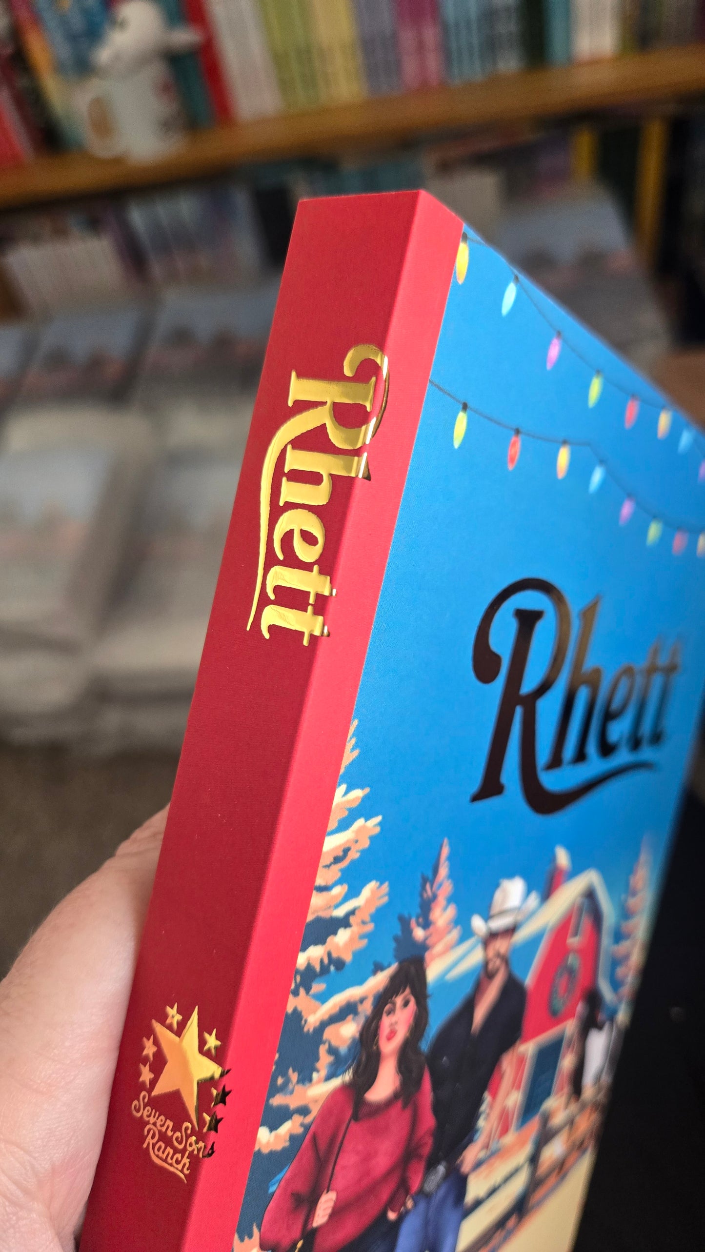 Close-up of a Rhett chocolate bar packaging with a blurred bookshelf background