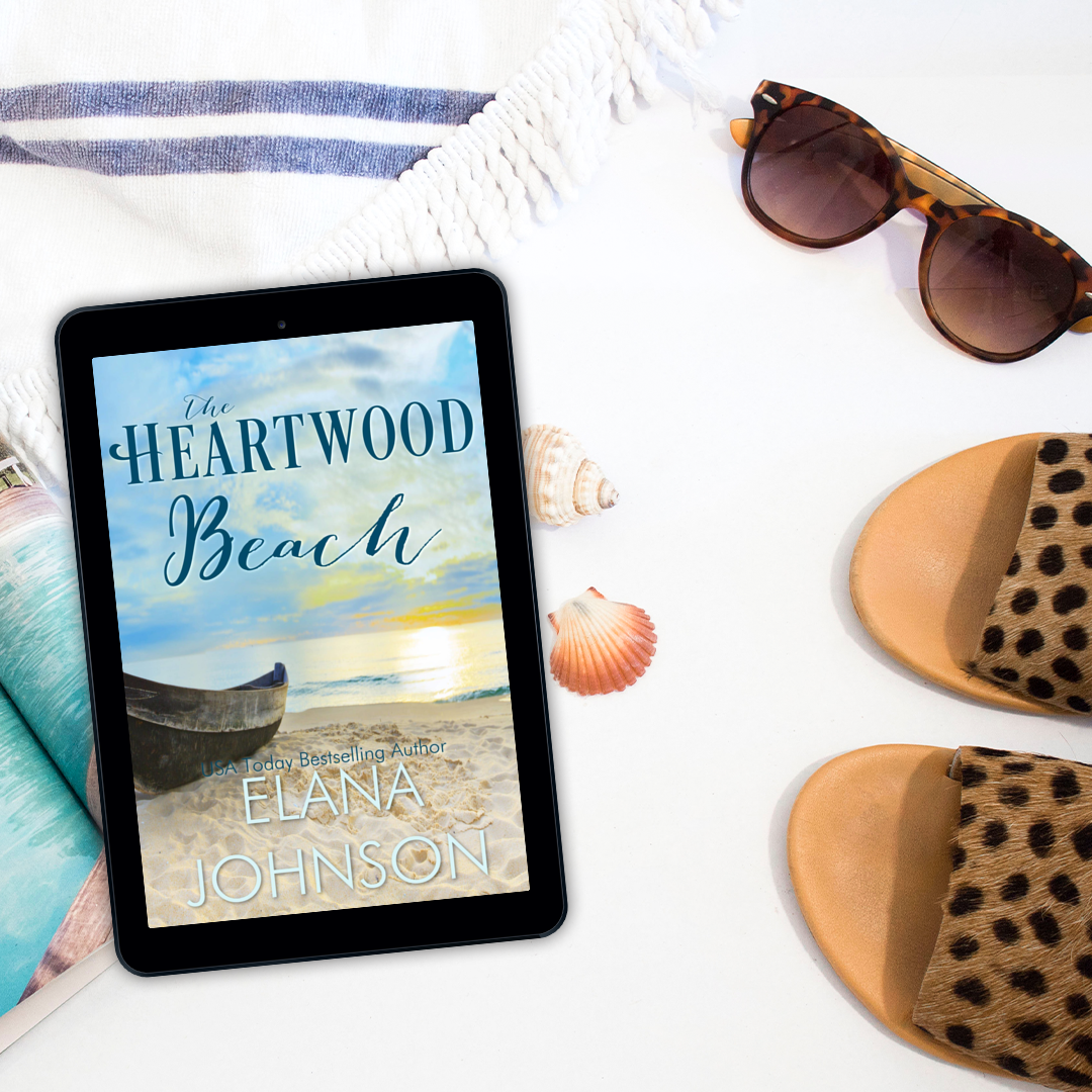 E-reader displaying the cover of The Heartwood Beach by Elana Jonson on a white background with beach items.