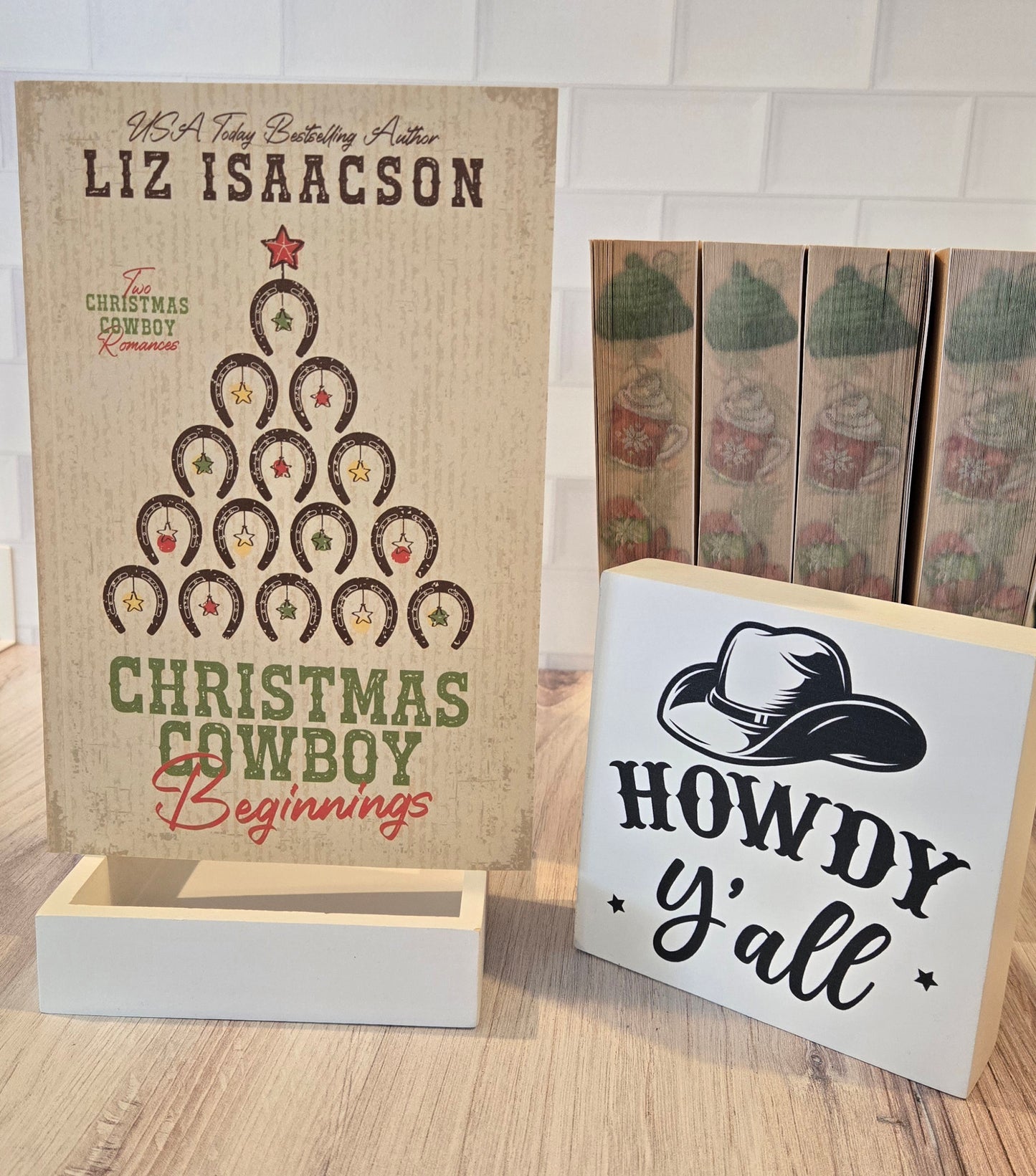 Two wooden signs with decorative text and graphics on a wooden surface.