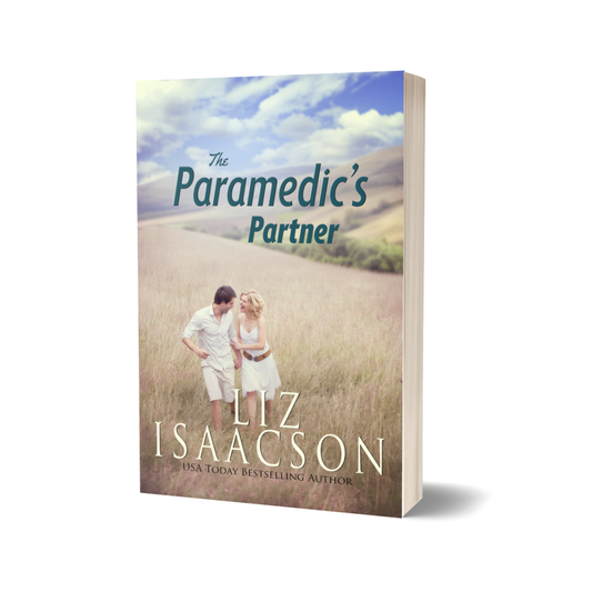 Cover of The Paramedic's Partner by Liz Isaacson featuring a couple in a field. 