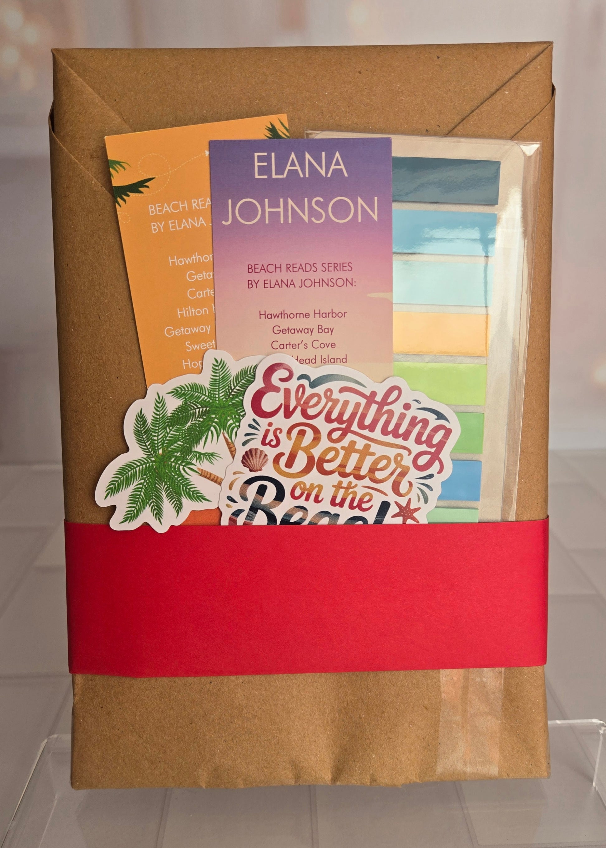 Book packaging with a book, card, and sticker on a brown envelope.