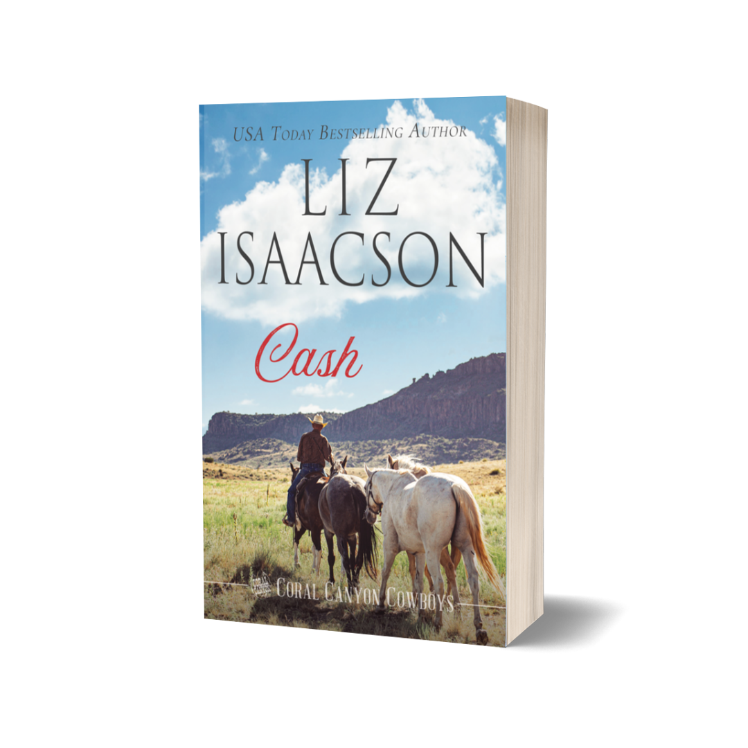 Book cover of 'Cash' by Liz Isaacson with a scenic view and two horses on a white background