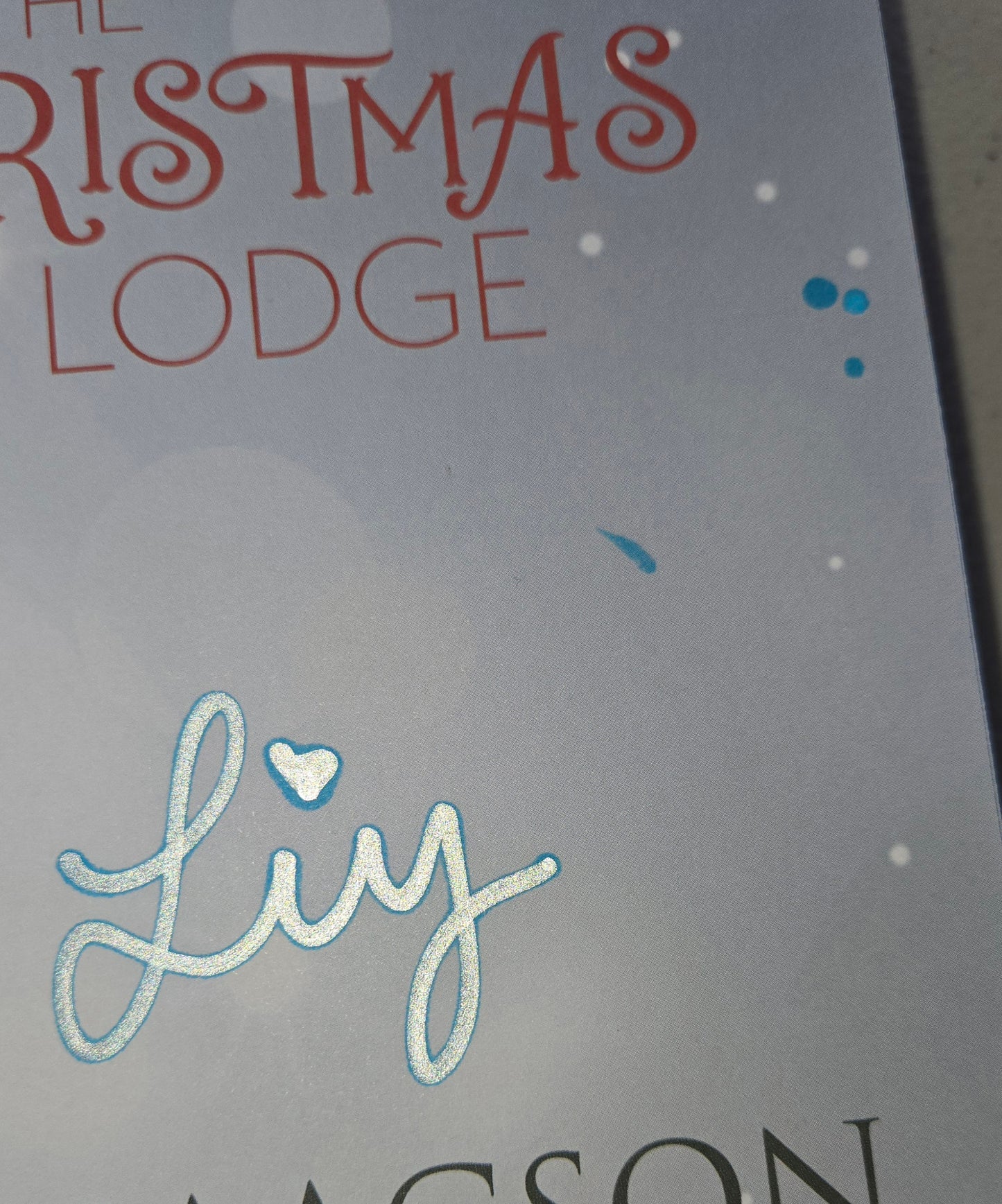The Christmas Lodge Special Edition paperback with ink bleed from the author signature.