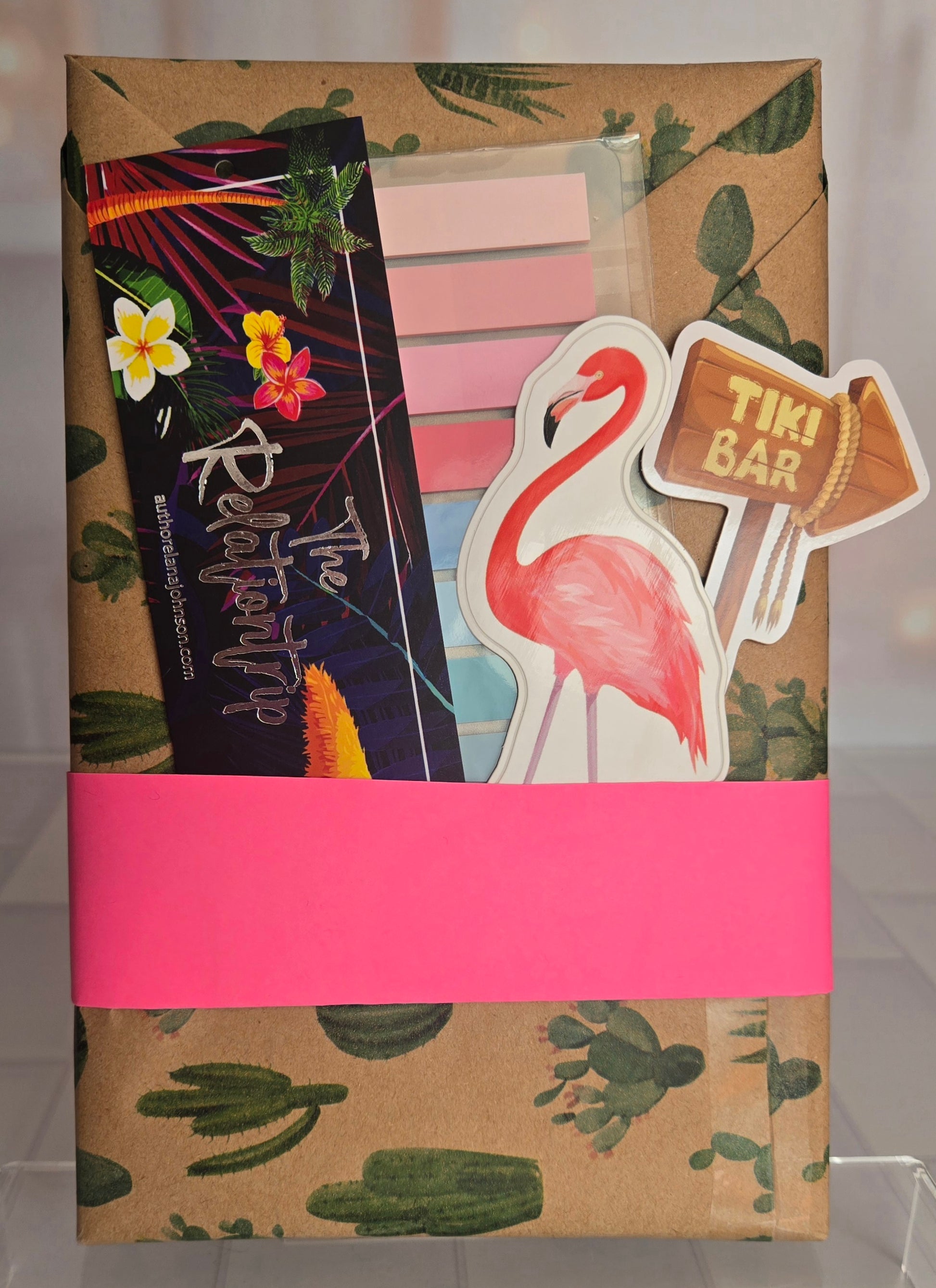 Packaged product with tropical design, flamingo, and 'Tiki Bar' sign on a neutral background