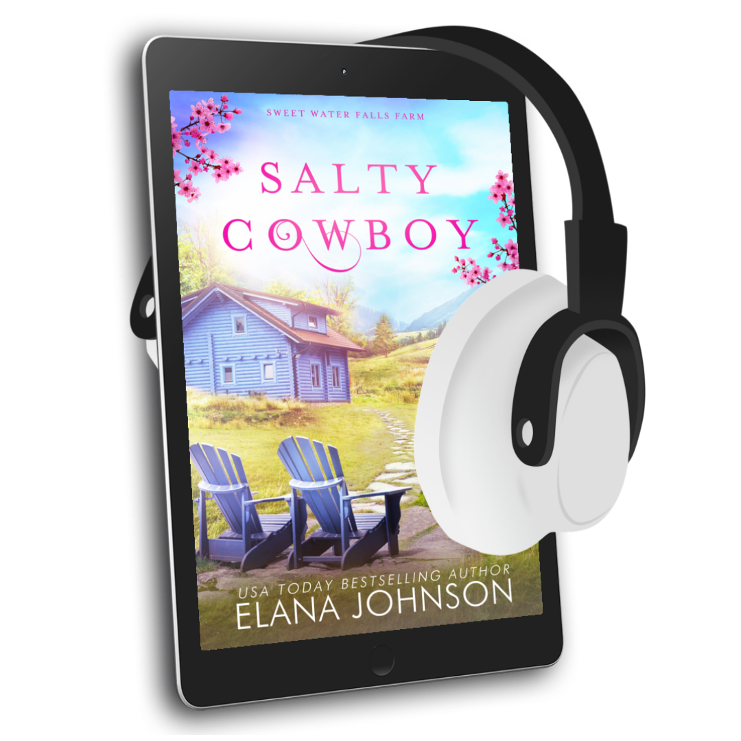 A tablet displaying the book cover of 'Salty Cowboy' by Elana Johnson, with white and black over-ear headphones floating beside it on a clean white background.