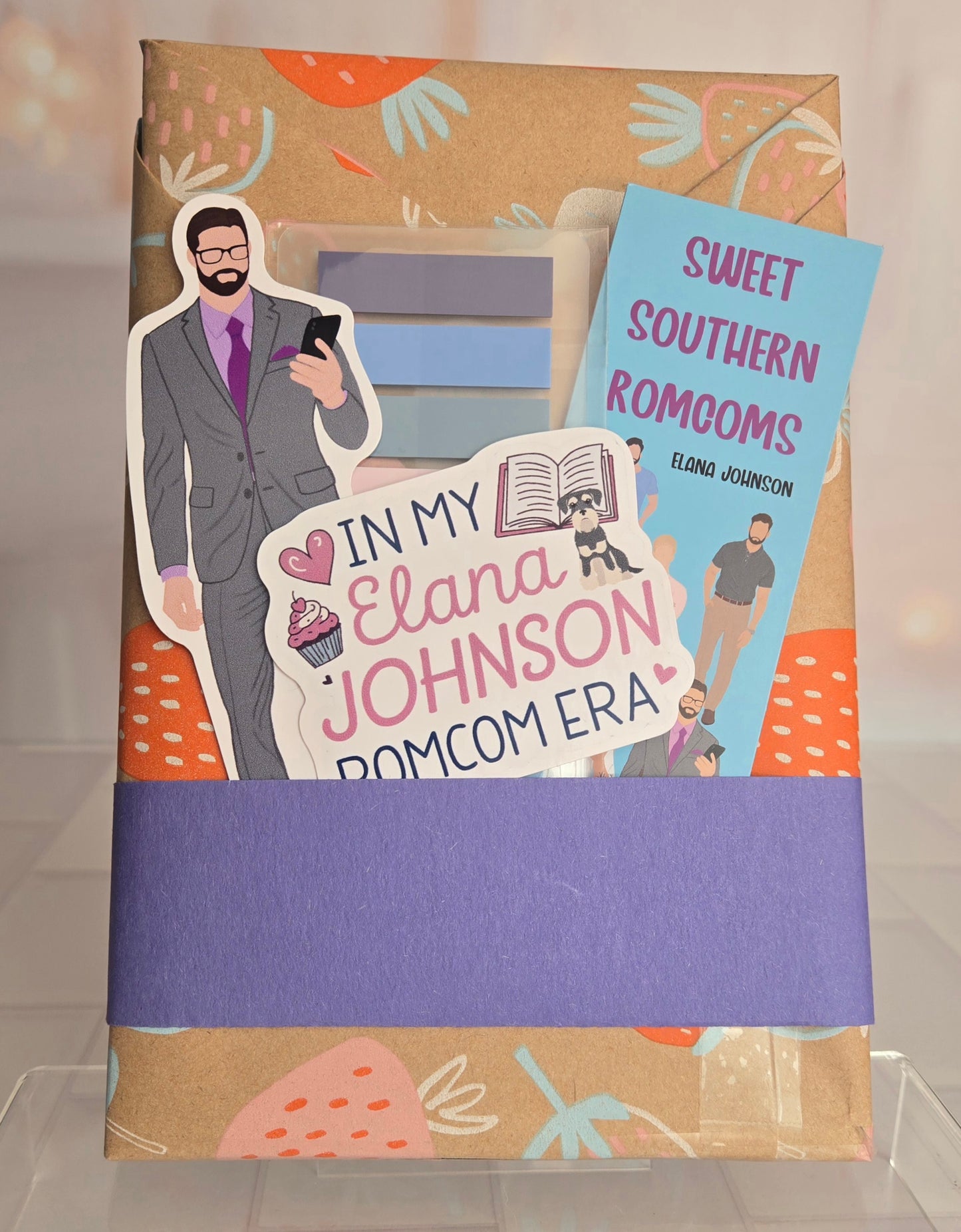 Book with a character cutout and promotional text for 'Sweet Southern Romcoms' by Eland Johnson.