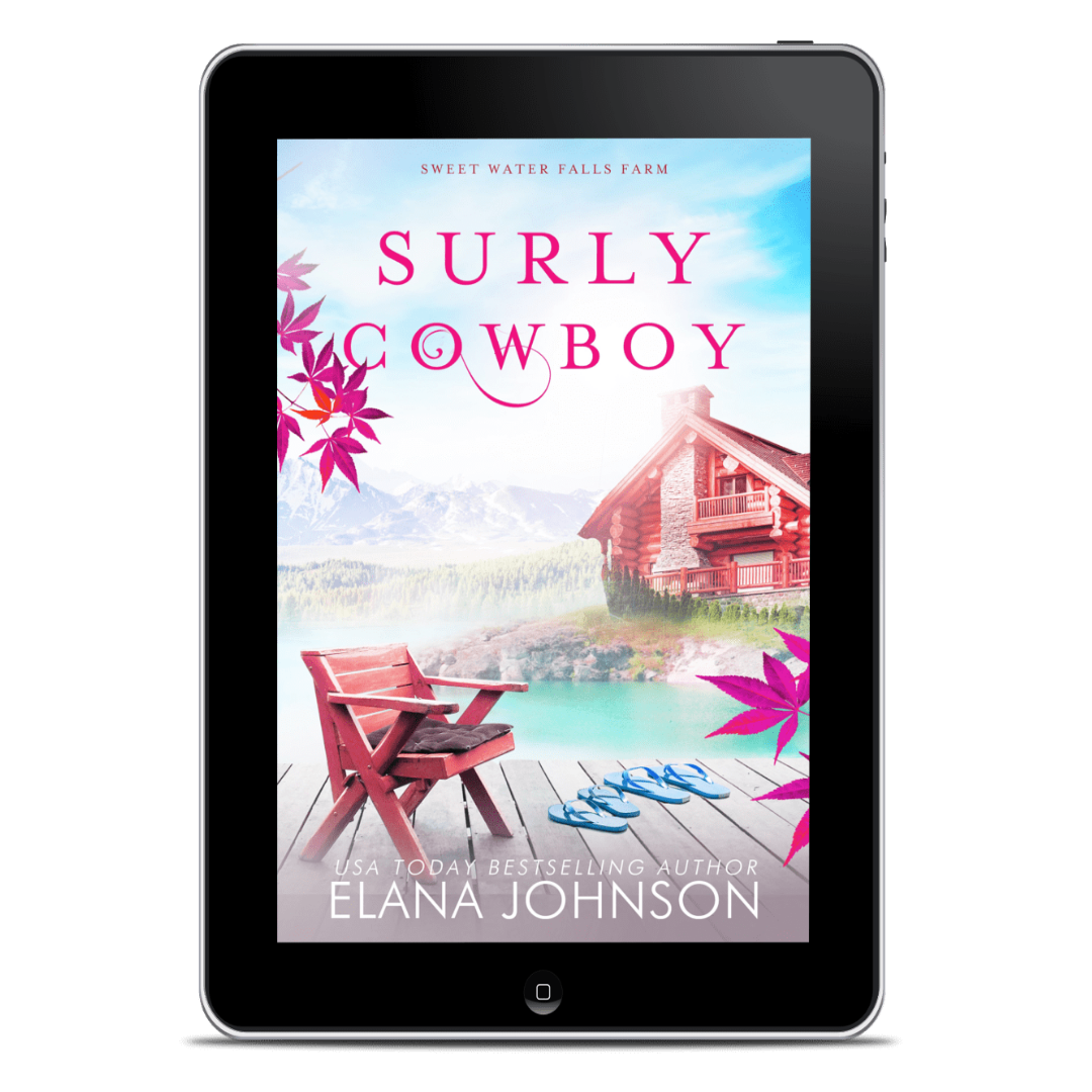 A tablet device displaying the book cover for 'Surly Cowboy' by Elana Johnson, set against a plain white background.